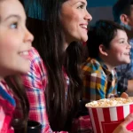 Families sitting in a cinema enjoying themselves