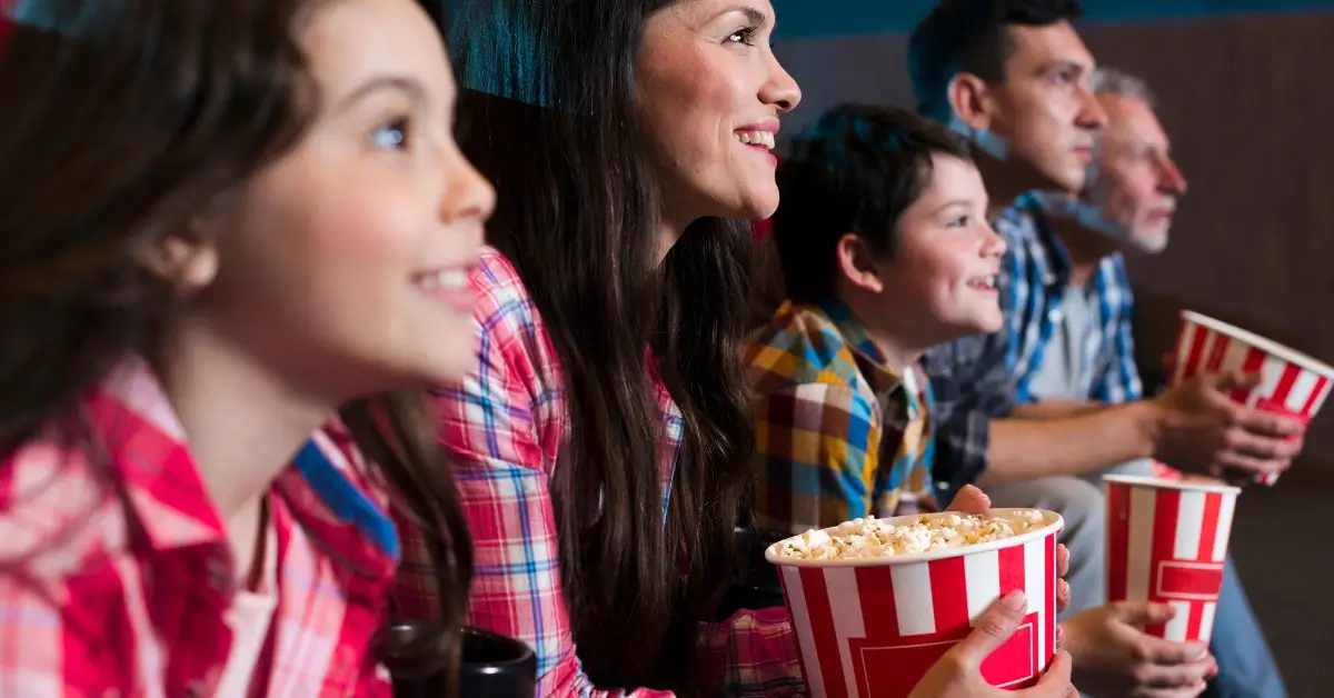 Families sitting in a cinema enjoying themselves